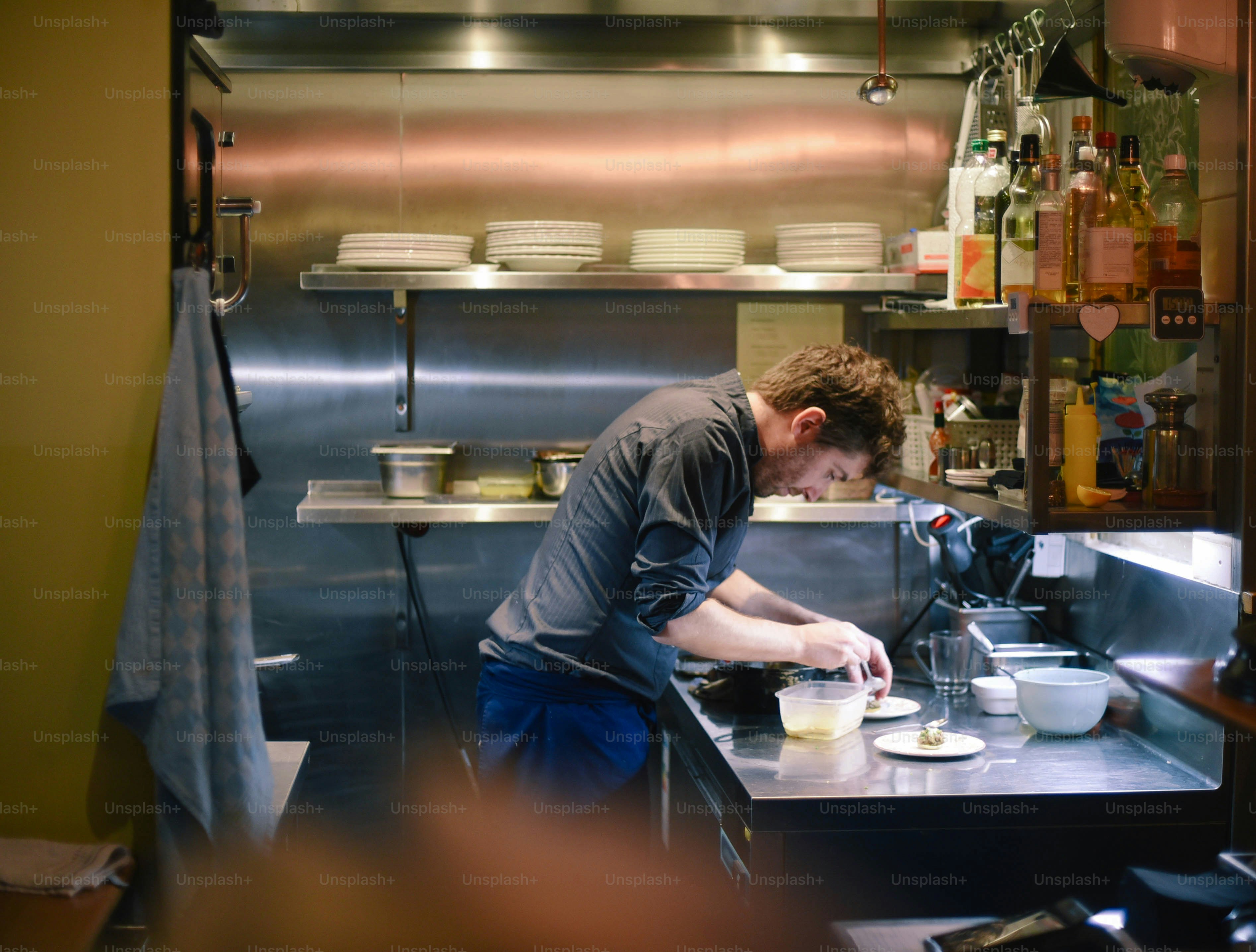a man is preparing food in a kitchen