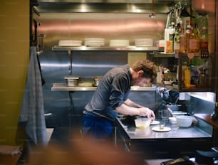 a man is preparing food in a kitchen