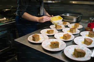 a person is putting a piece of cake on a plate