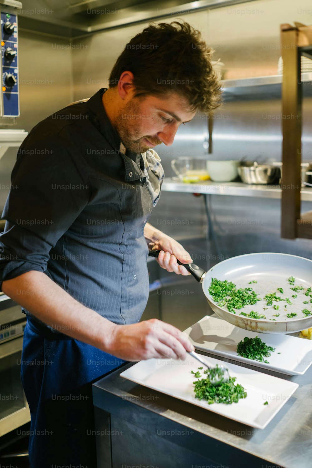 a man in a kitchen preparing food on a cutting board