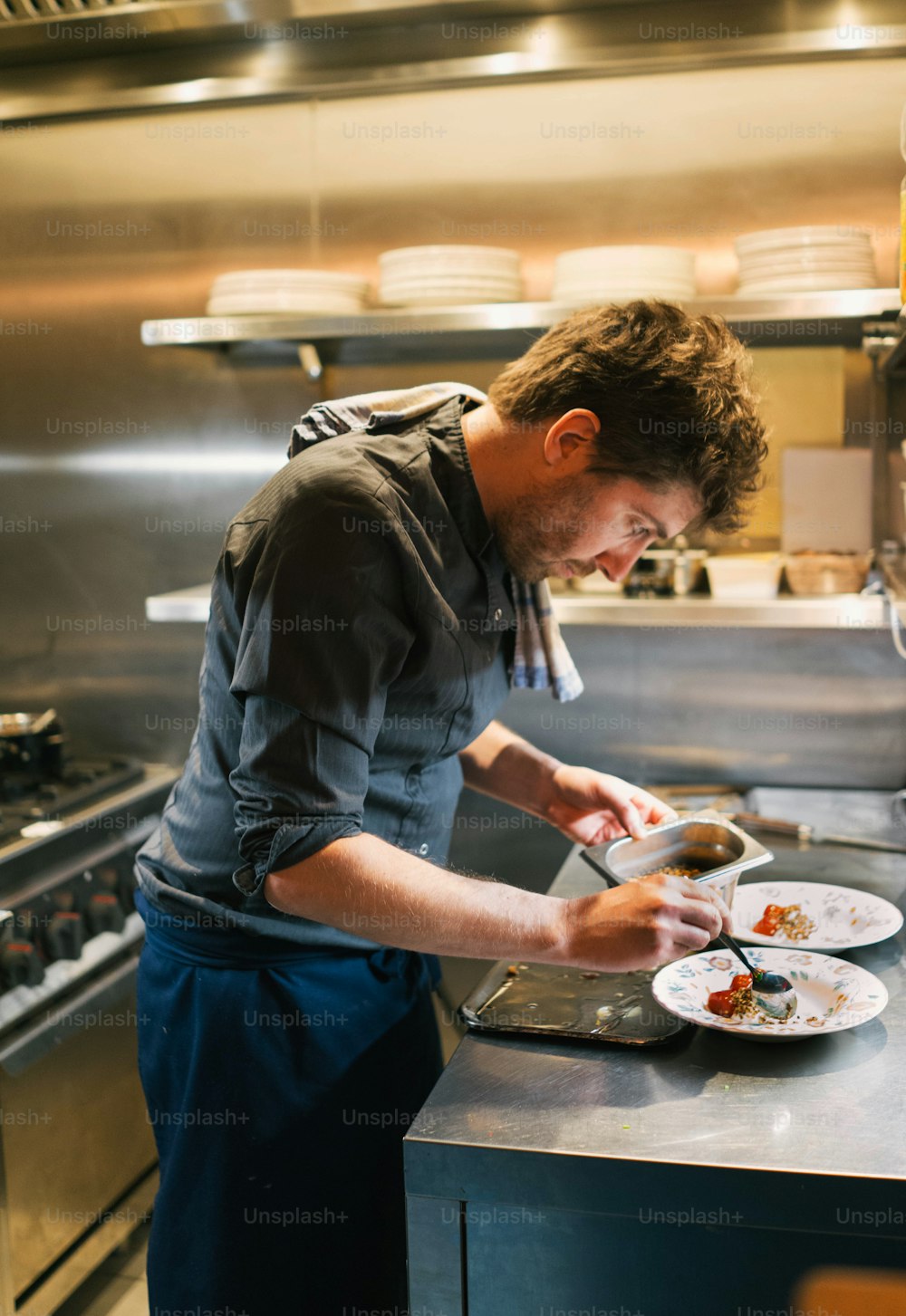 a man standing in a kitchen preparing food