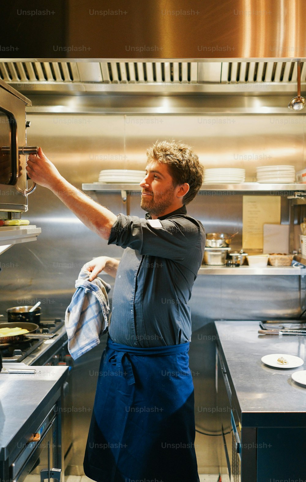 a man that is standing in a kitchen