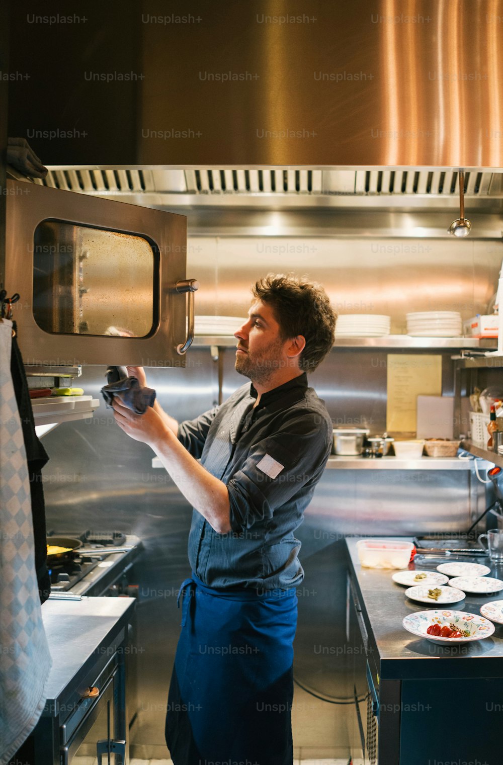 a man standing in a kitchen preparing food