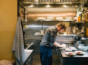 a man preparing food in a commercial kitchen