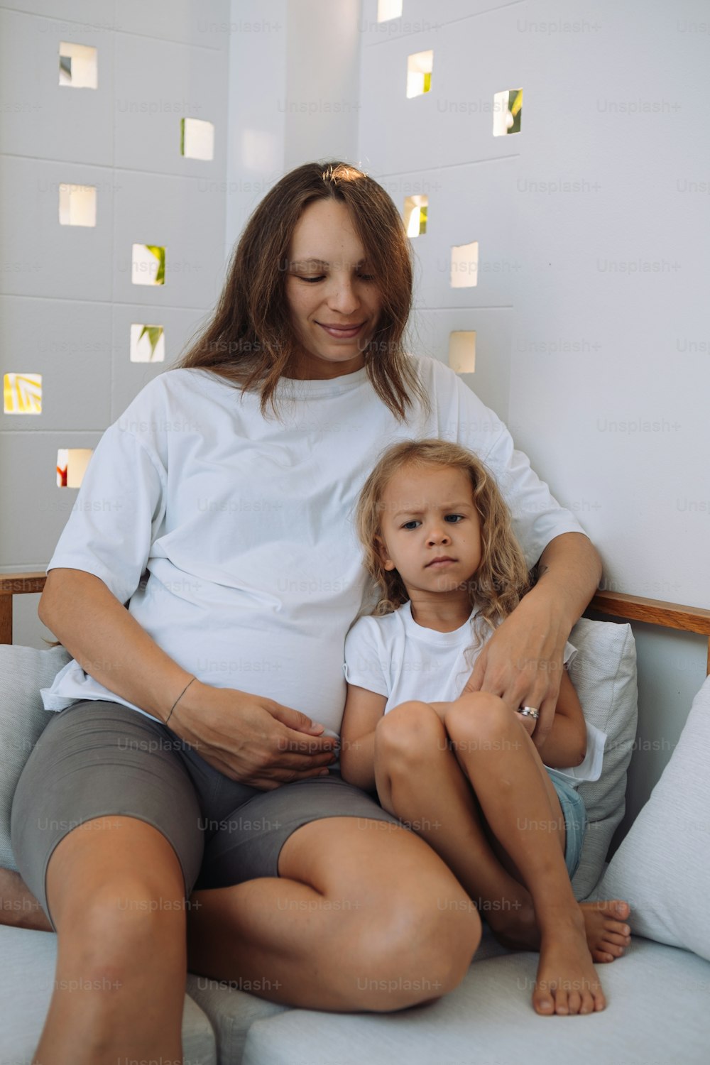 a woman and a child sitting on a couch