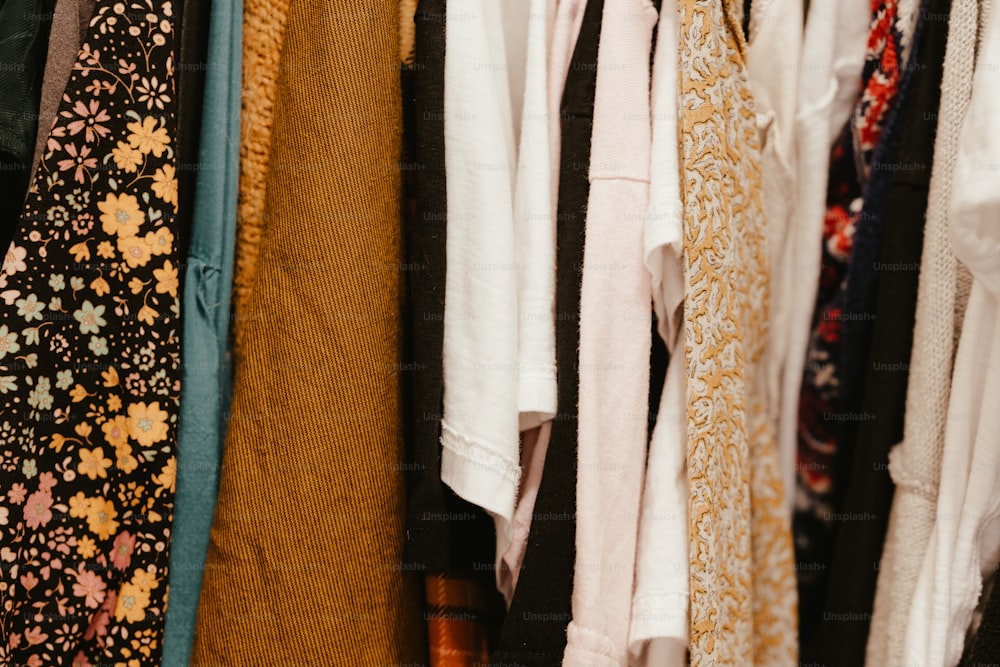 a bunch of clothes hanging on a rack