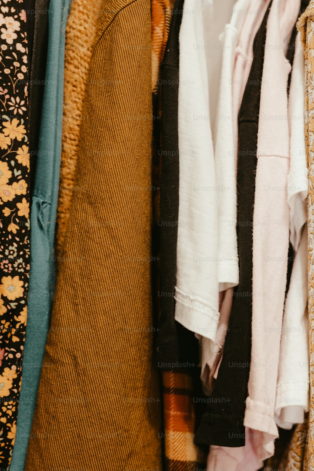 a bunch of clothes hanging on a rack