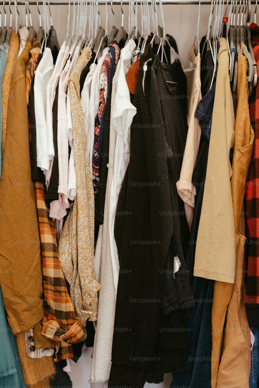 a bunch of clothes hanging on a rack