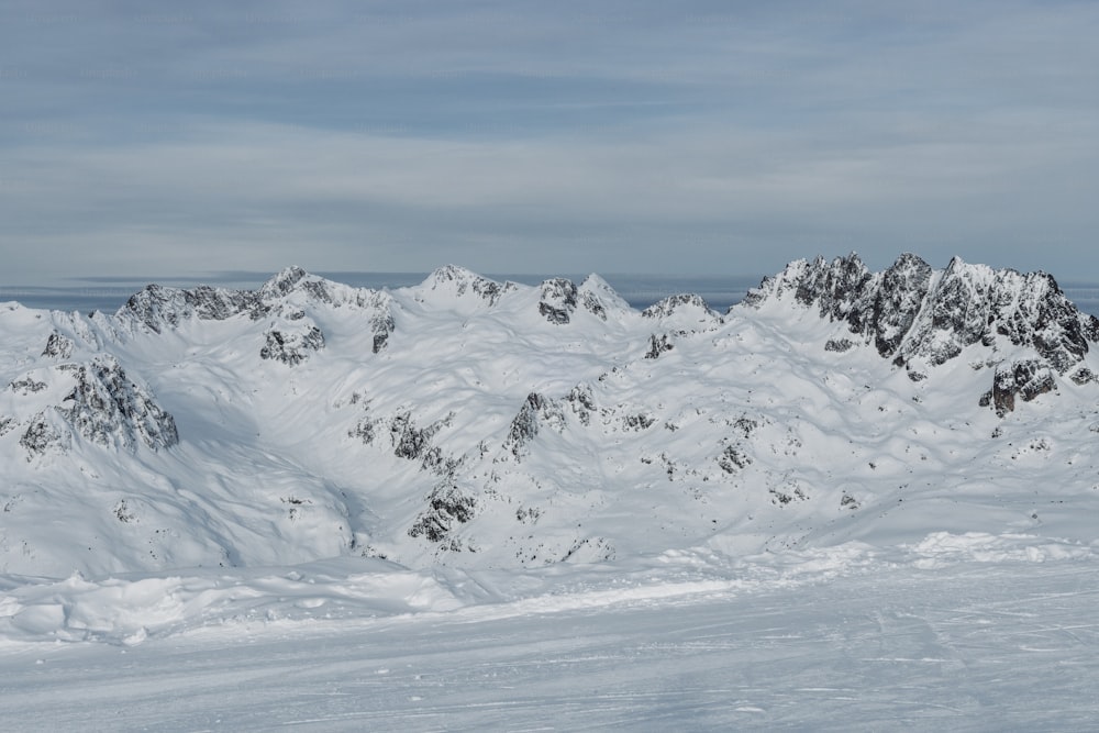 a man riding skis on top of a snow covered slope