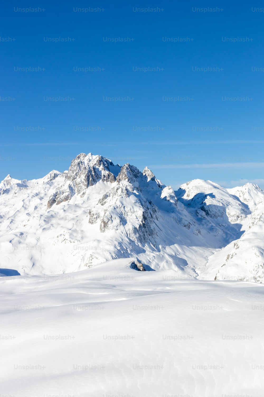a man riding skis on top of a snow covered slope