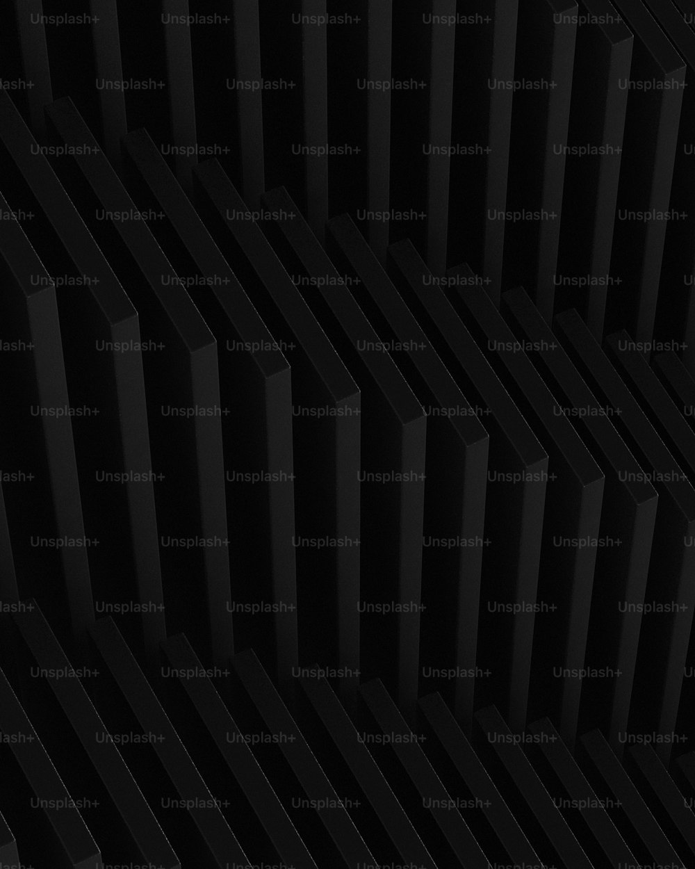 a close up of a black wall with a pattern on it