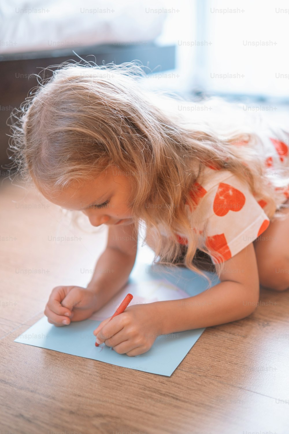 a little girl writing on a piece of paper