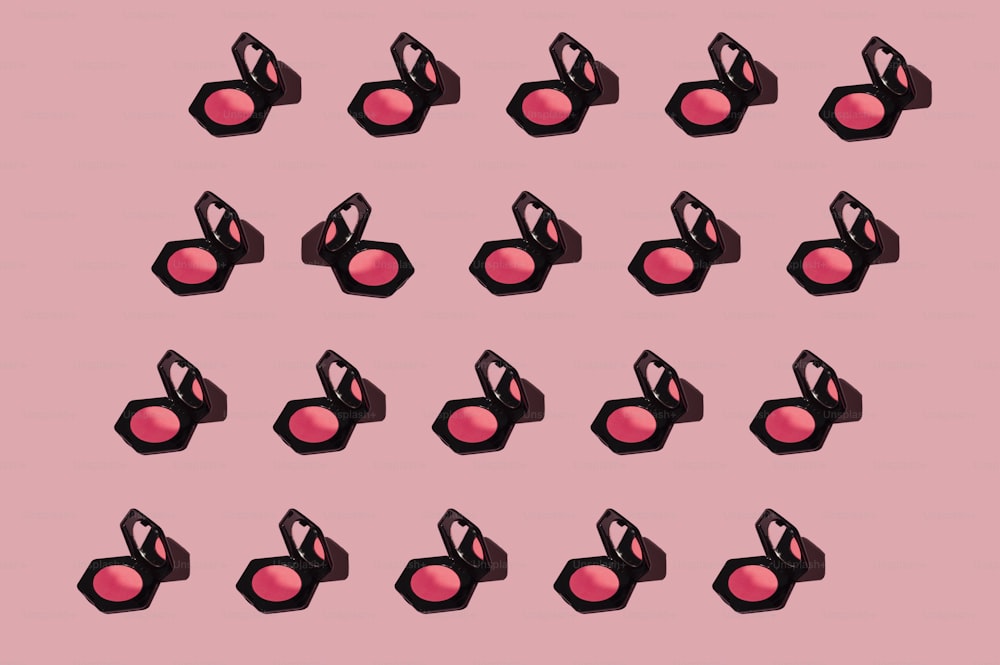 a pink background with a lot of black and pink lipstick