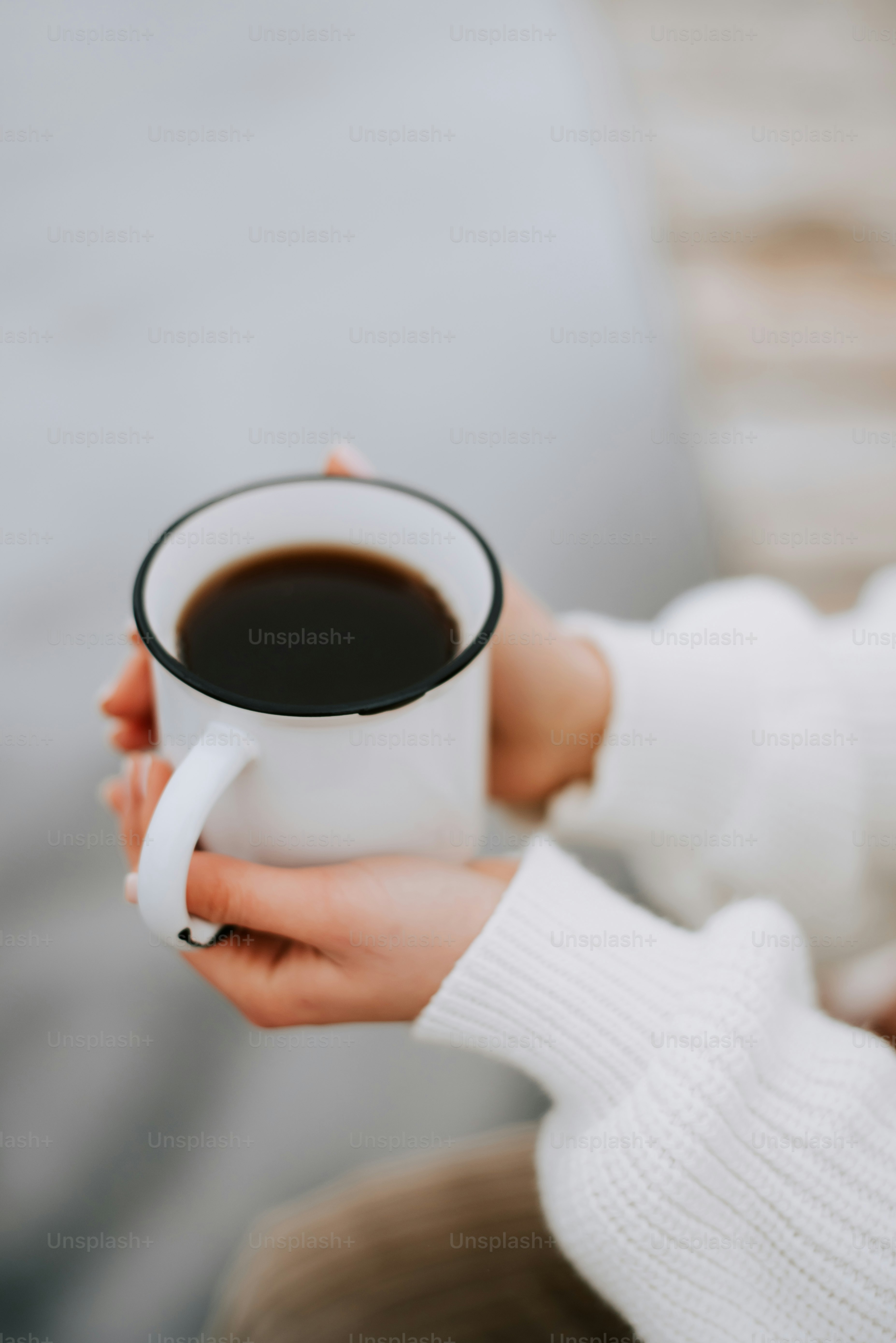 a woman holding a cup of coffee in her hands