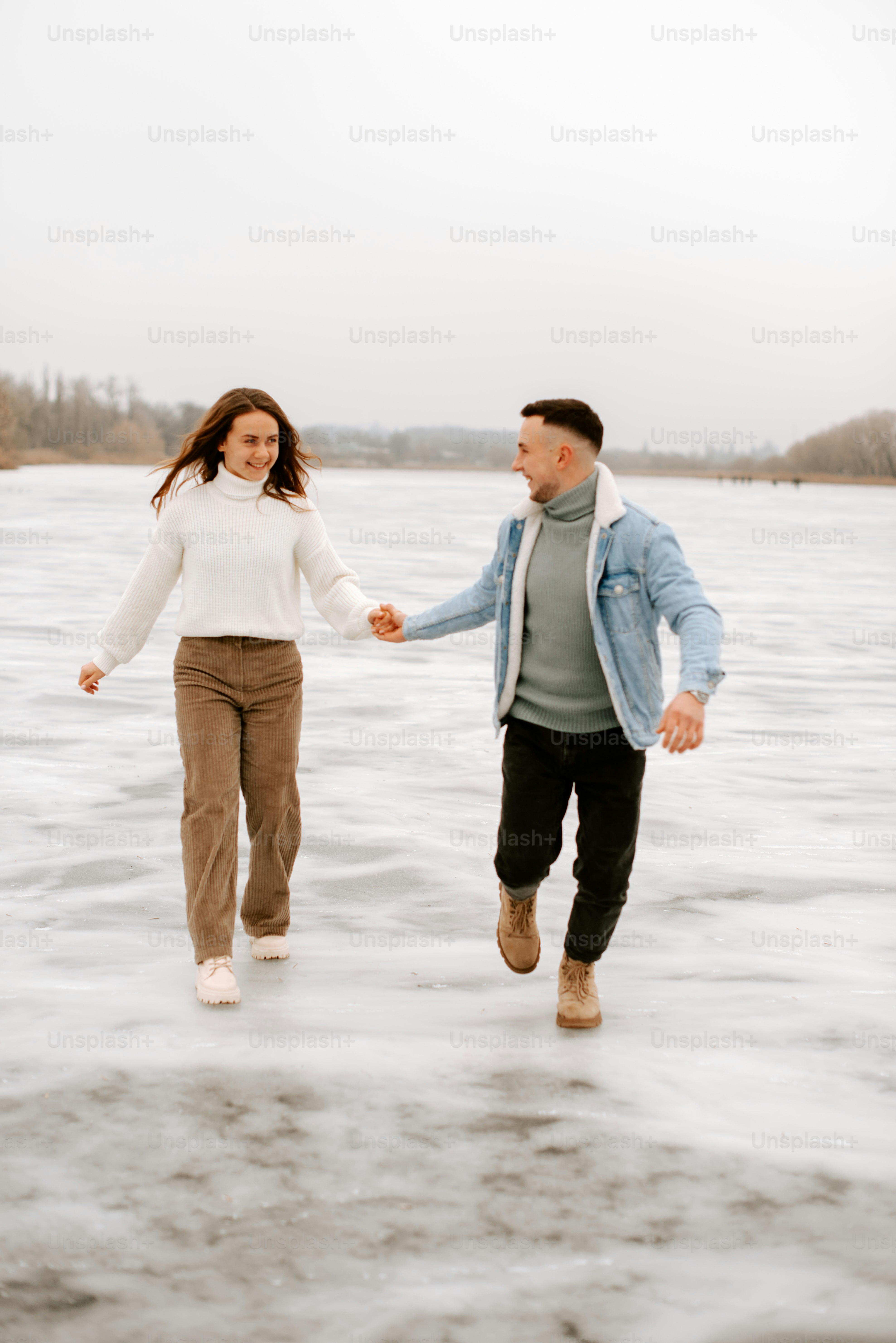 a man and a woman are walking in the water