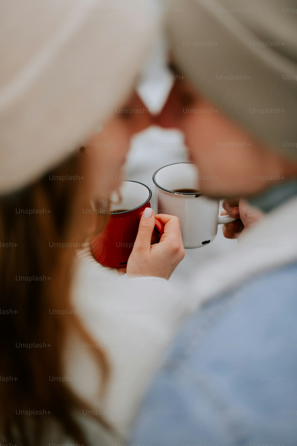 a man and a woman holding cups of coffee