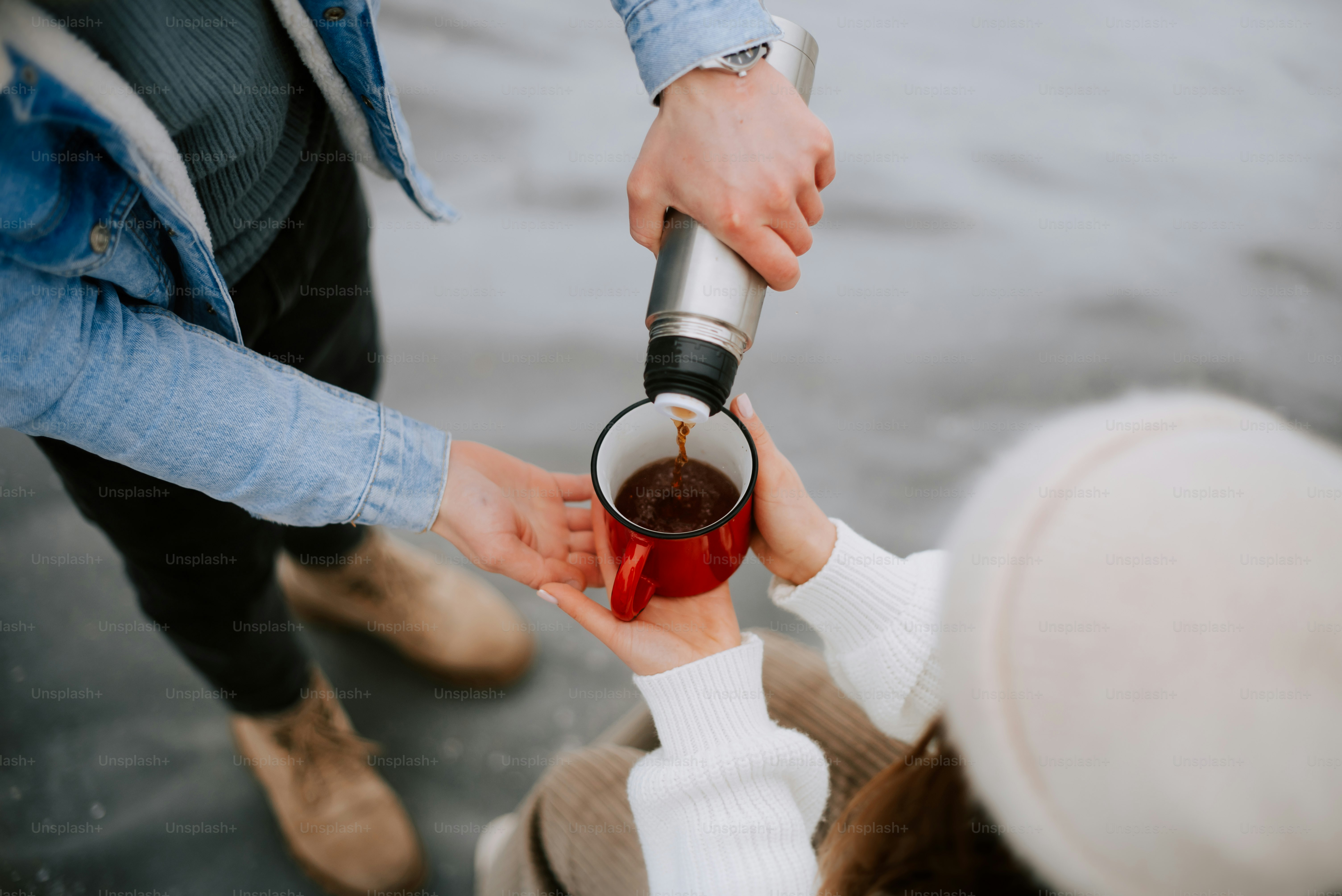 a couple of people that are holding a cup