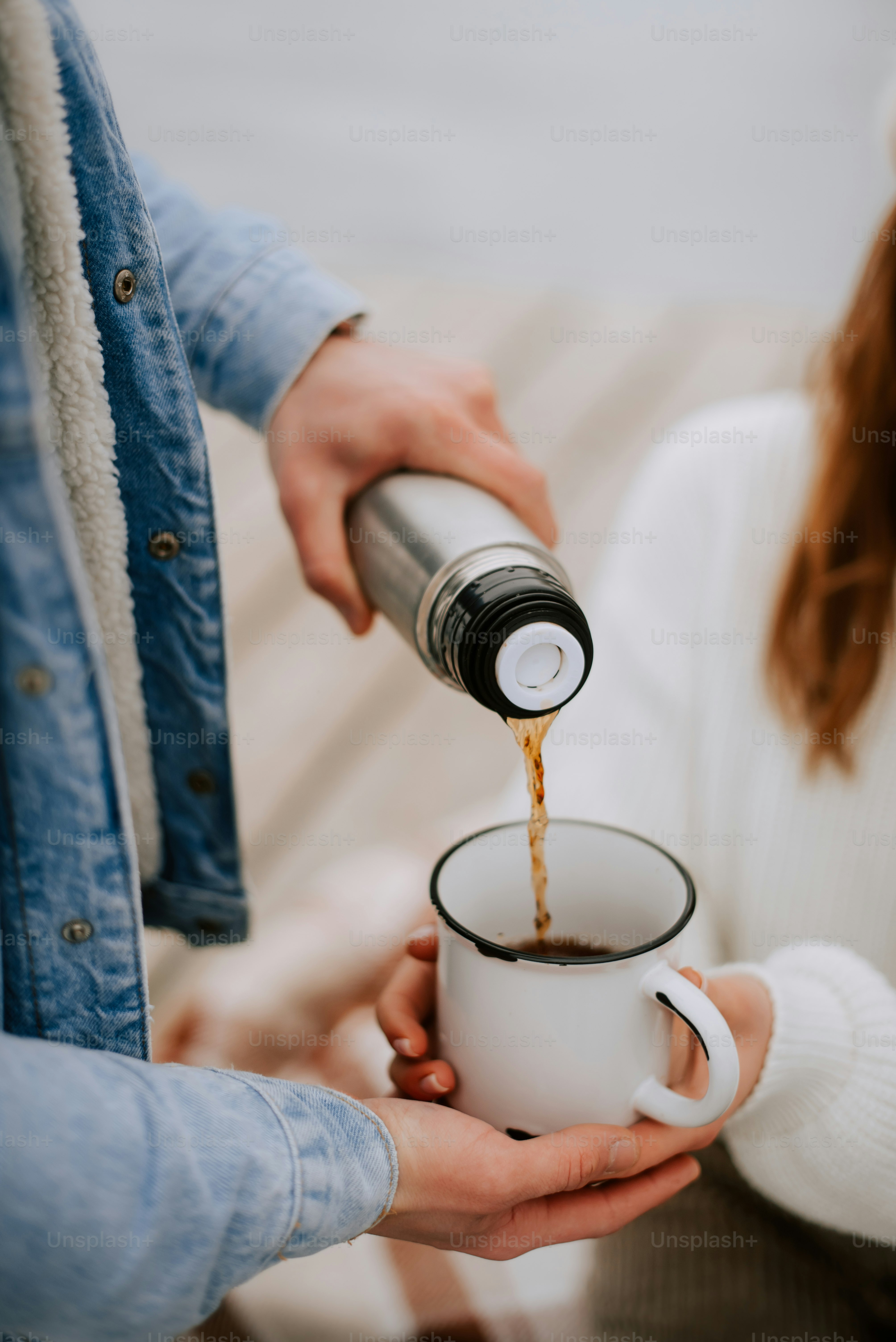 a person pouring coffee into a cup