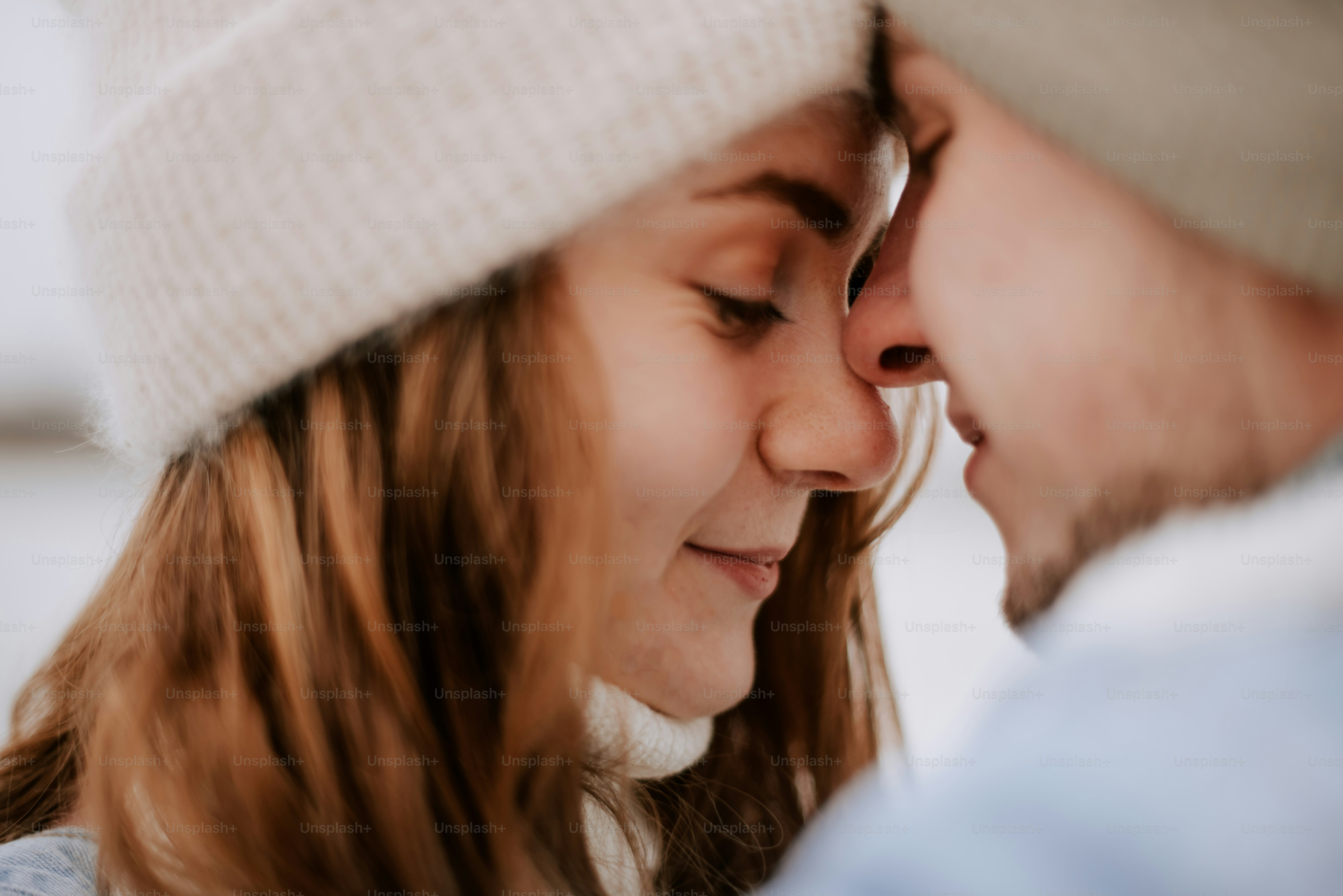 a close up of a person kissing another person