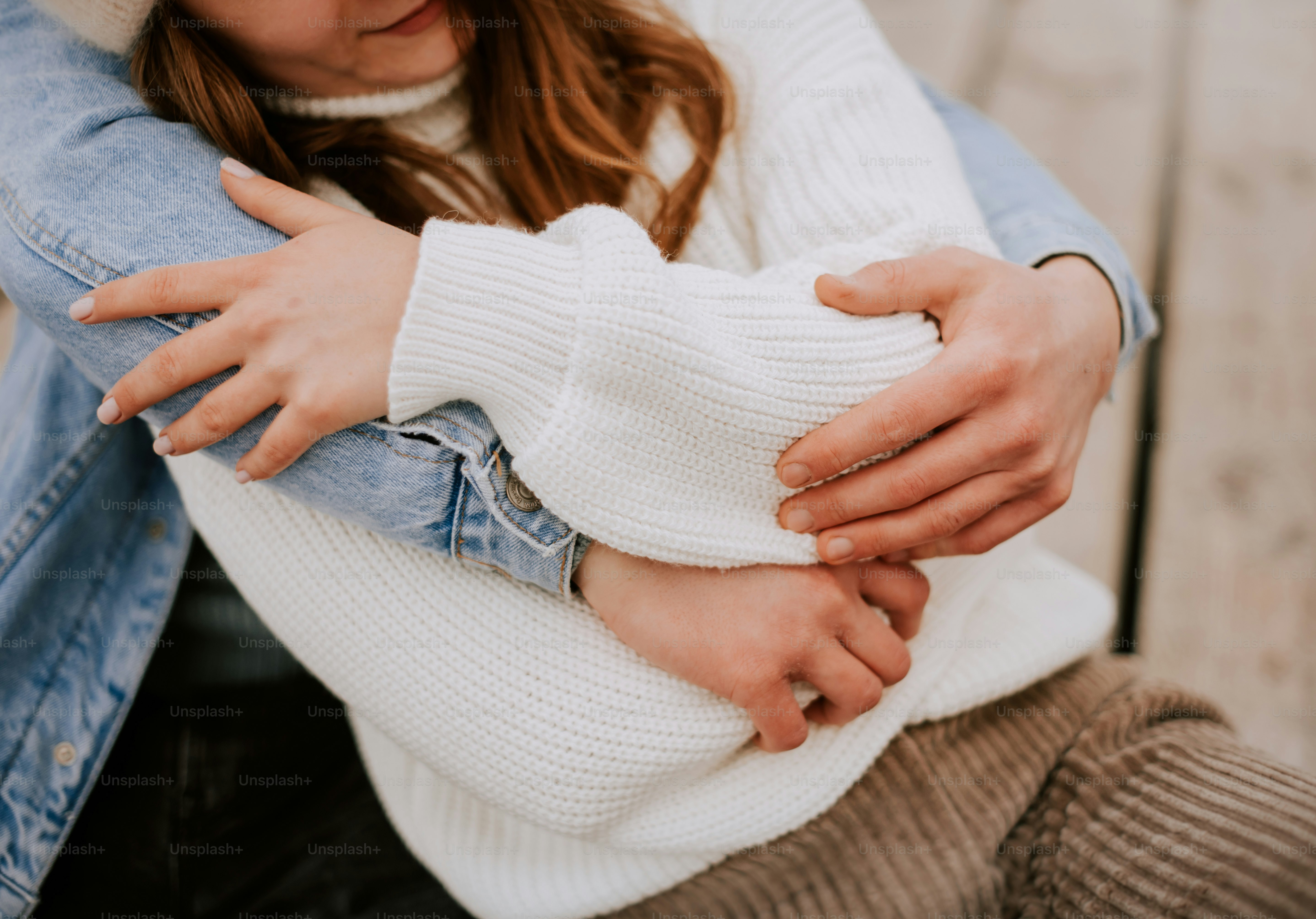 a man and a woman hugging on a bench