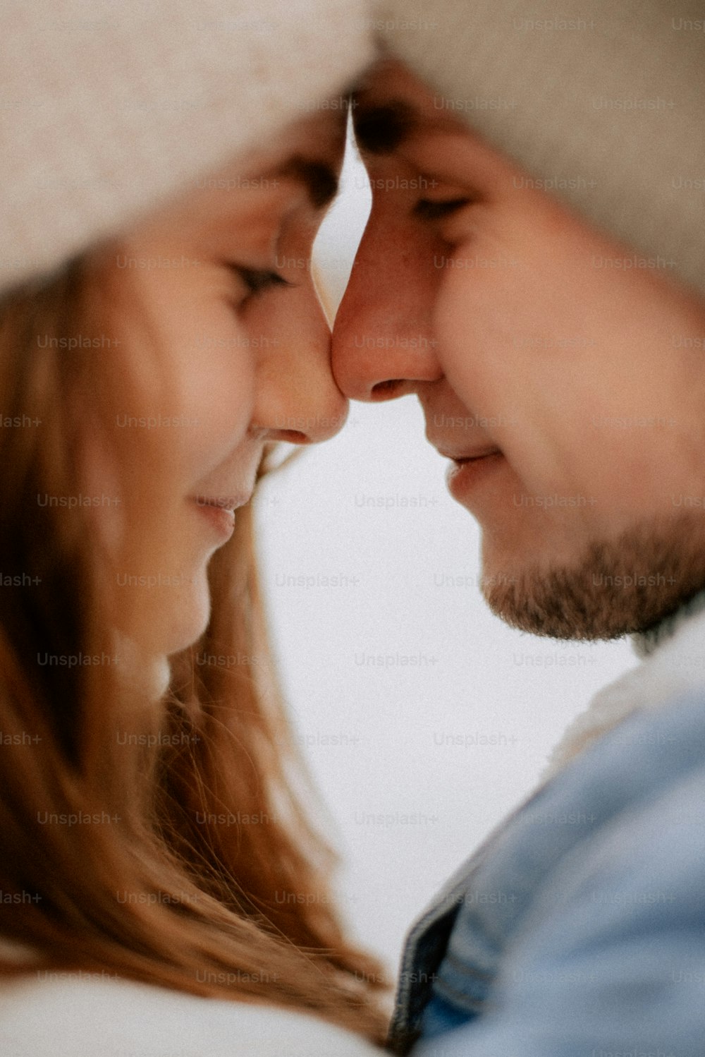 a close up of a man and a woman looking at each other