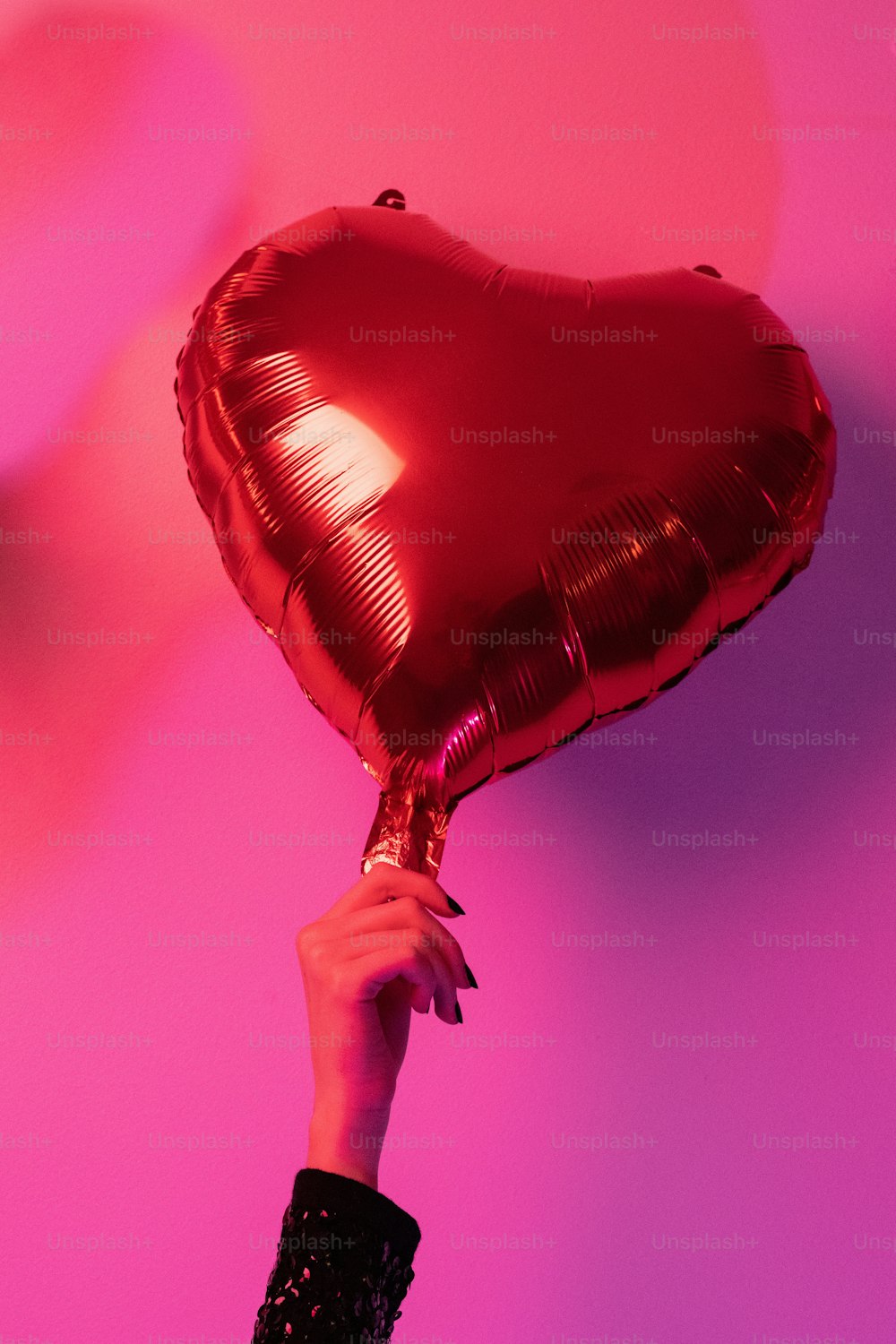 una persona sosteniendo un globo en forma de corazón