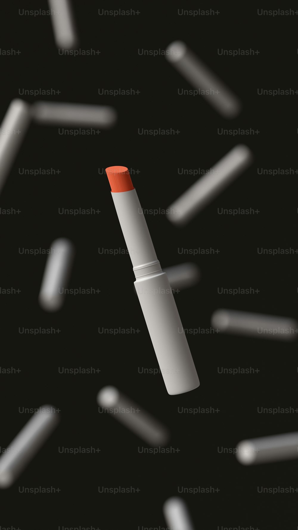 a red and white lipstick sitting on top of a black surface