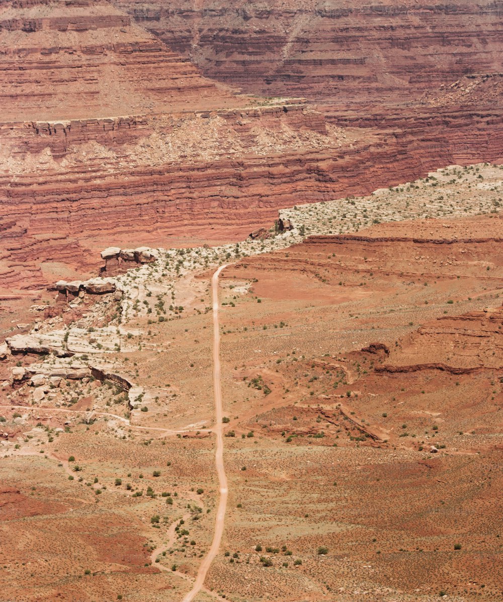 an aerial view of a dirt road in the desert