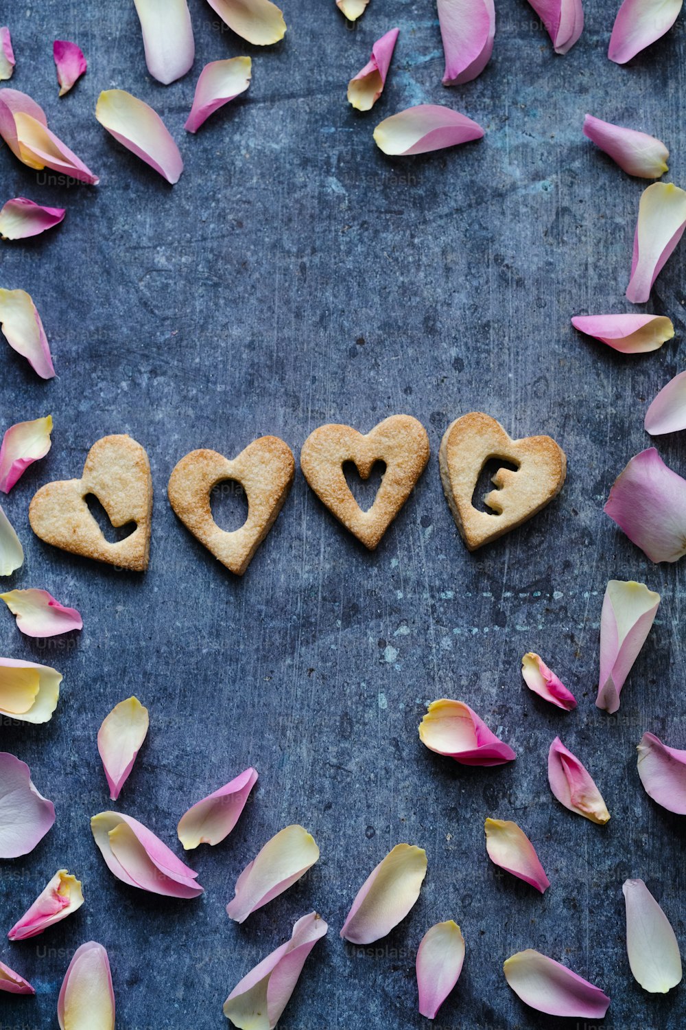 the word love spelled out in small hearts surrounded by petals