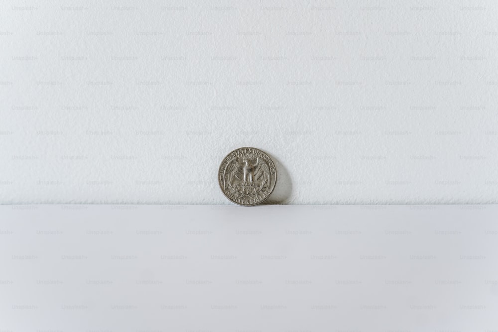 a coin sitting on top of a white surface