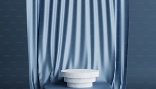 a white pedestal sitting in front of a blue curtain