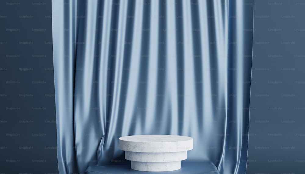 a white pedestal sitting in front of a blue curtain