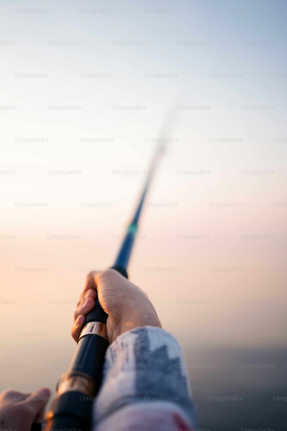 a person holding a fishing rod in their hand