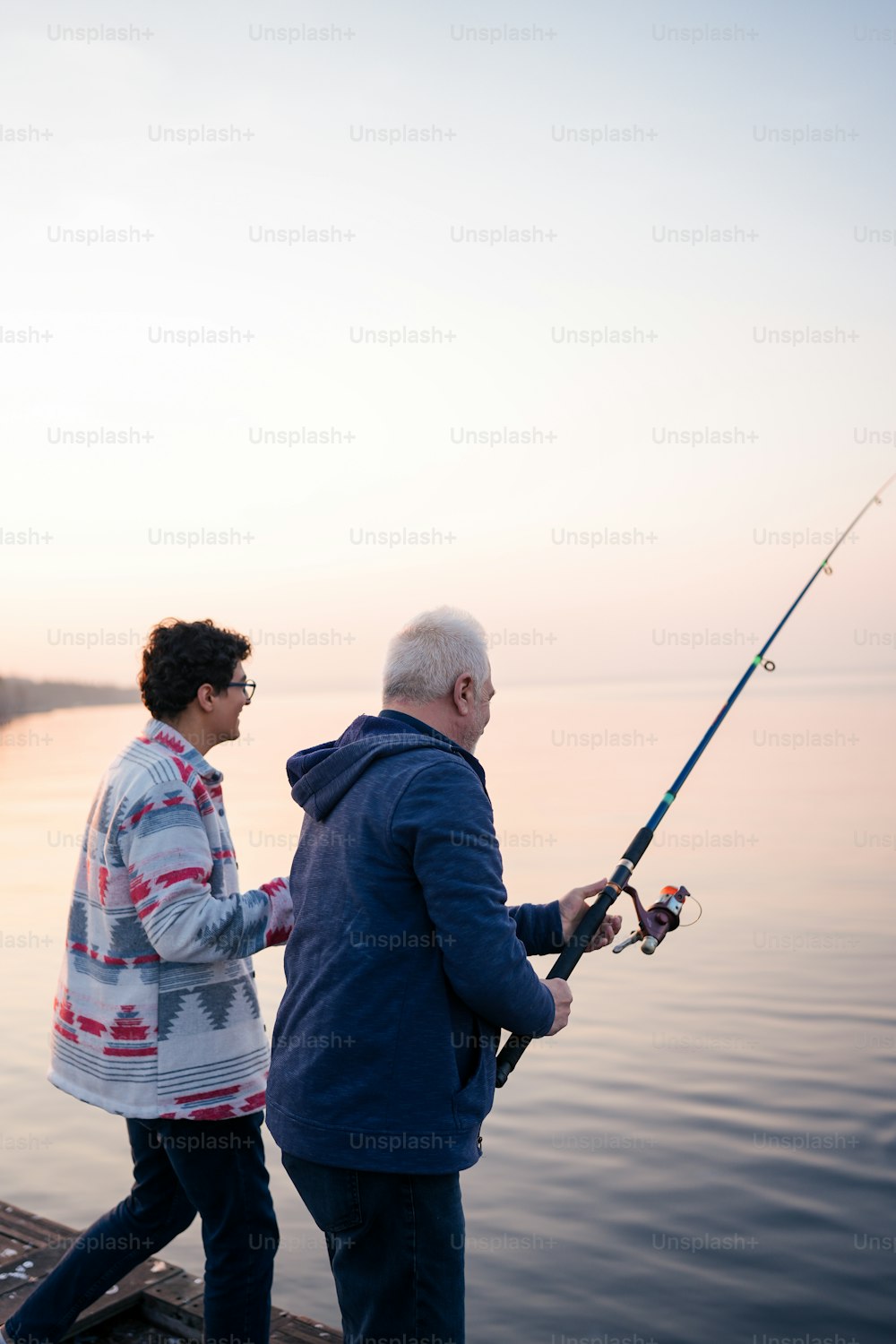 a man and a woman fishing on a dock