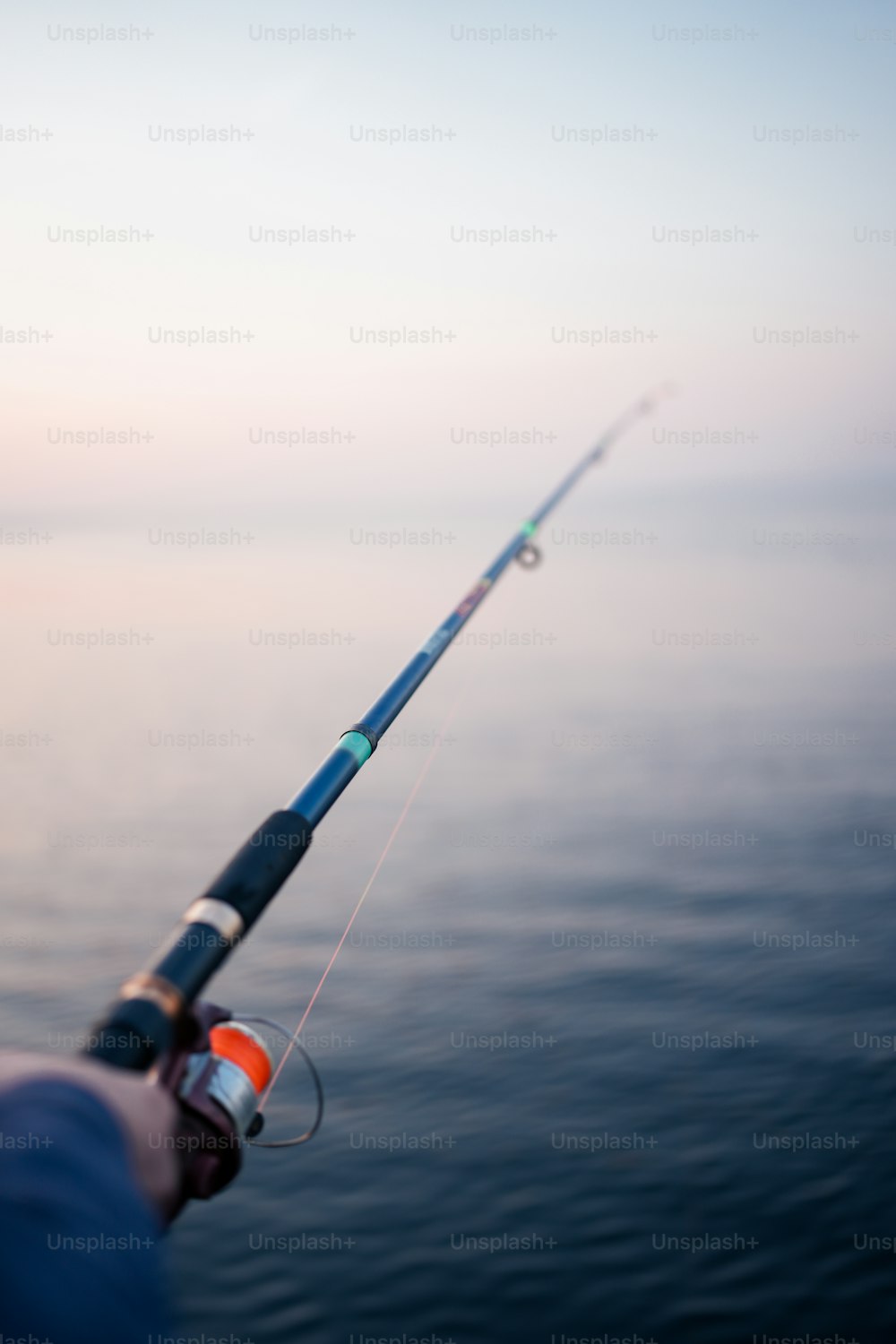 a person holding a fishing rod on a boat