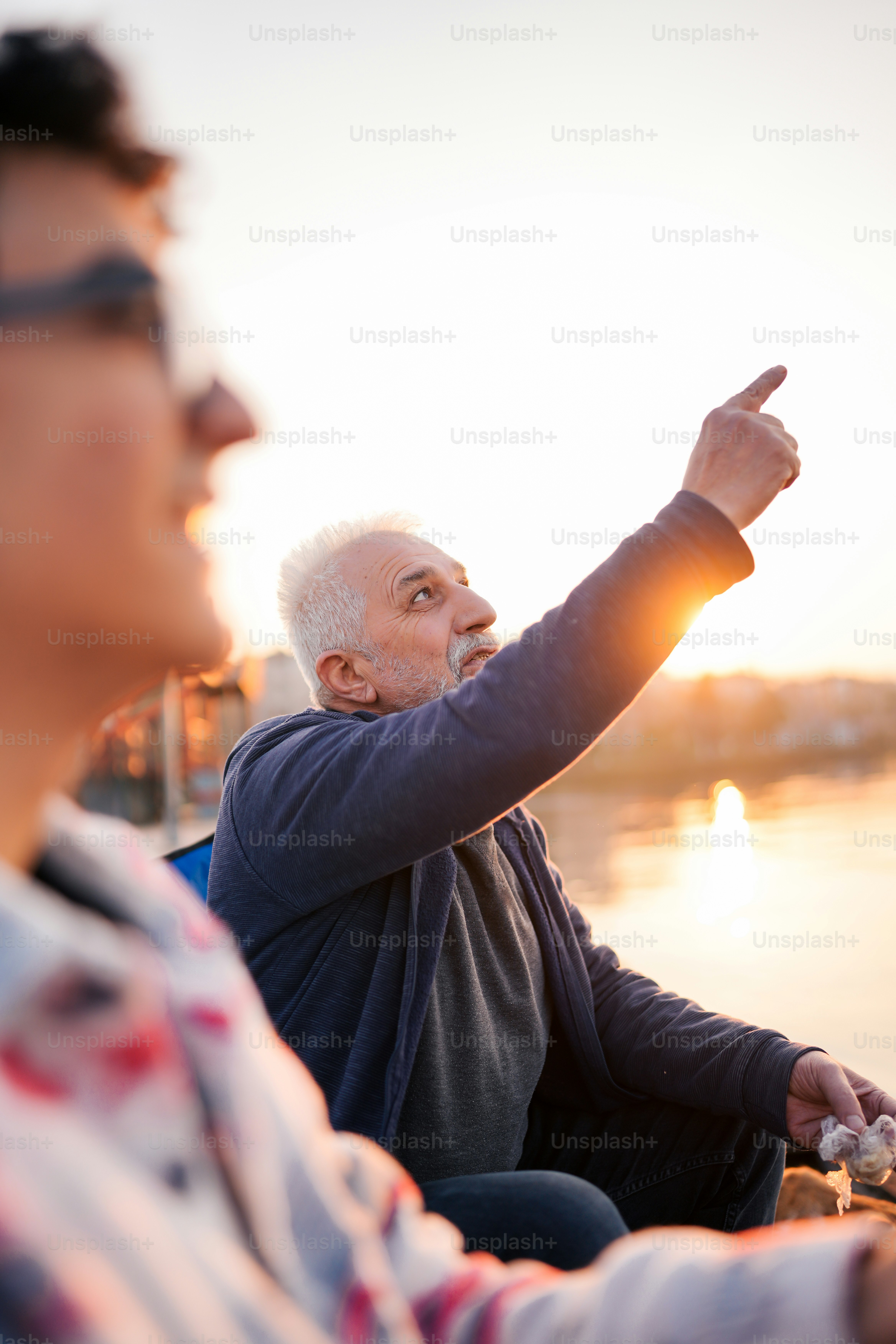 two men sitting next to each other on a boat