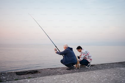 Rear view of man and his senior father fishing from a pier while spending  time together in nature. photo – Fishermen Image on Unsplash