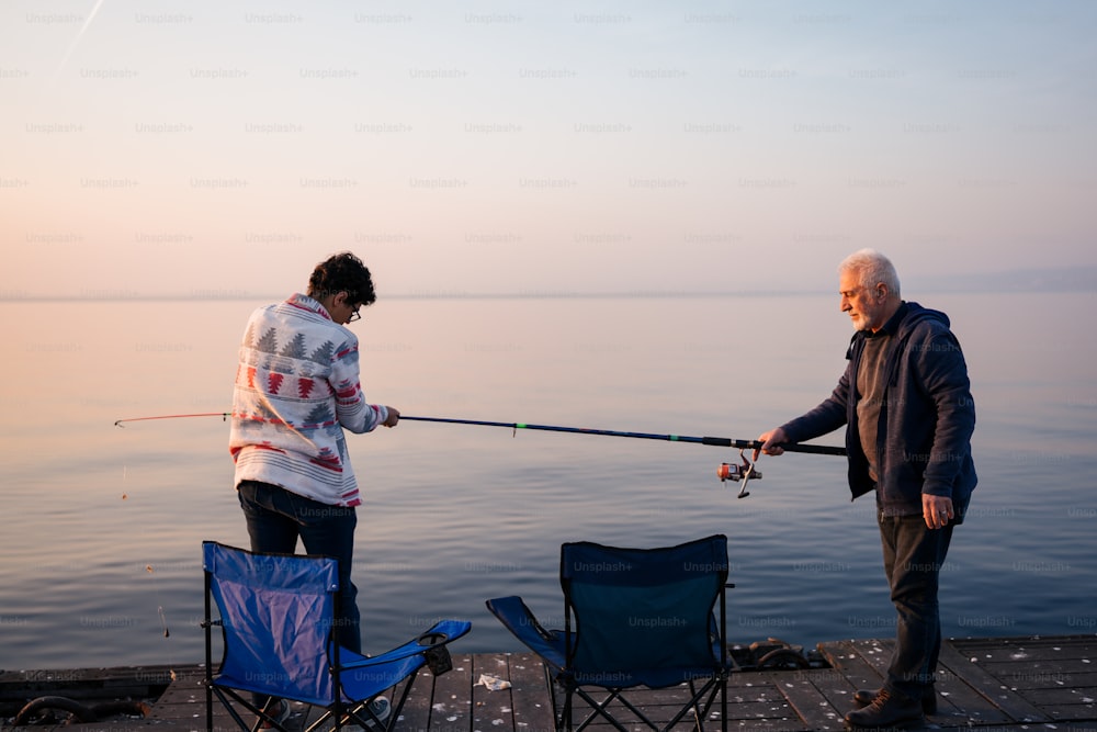 a man and a woman fishing on a dock
