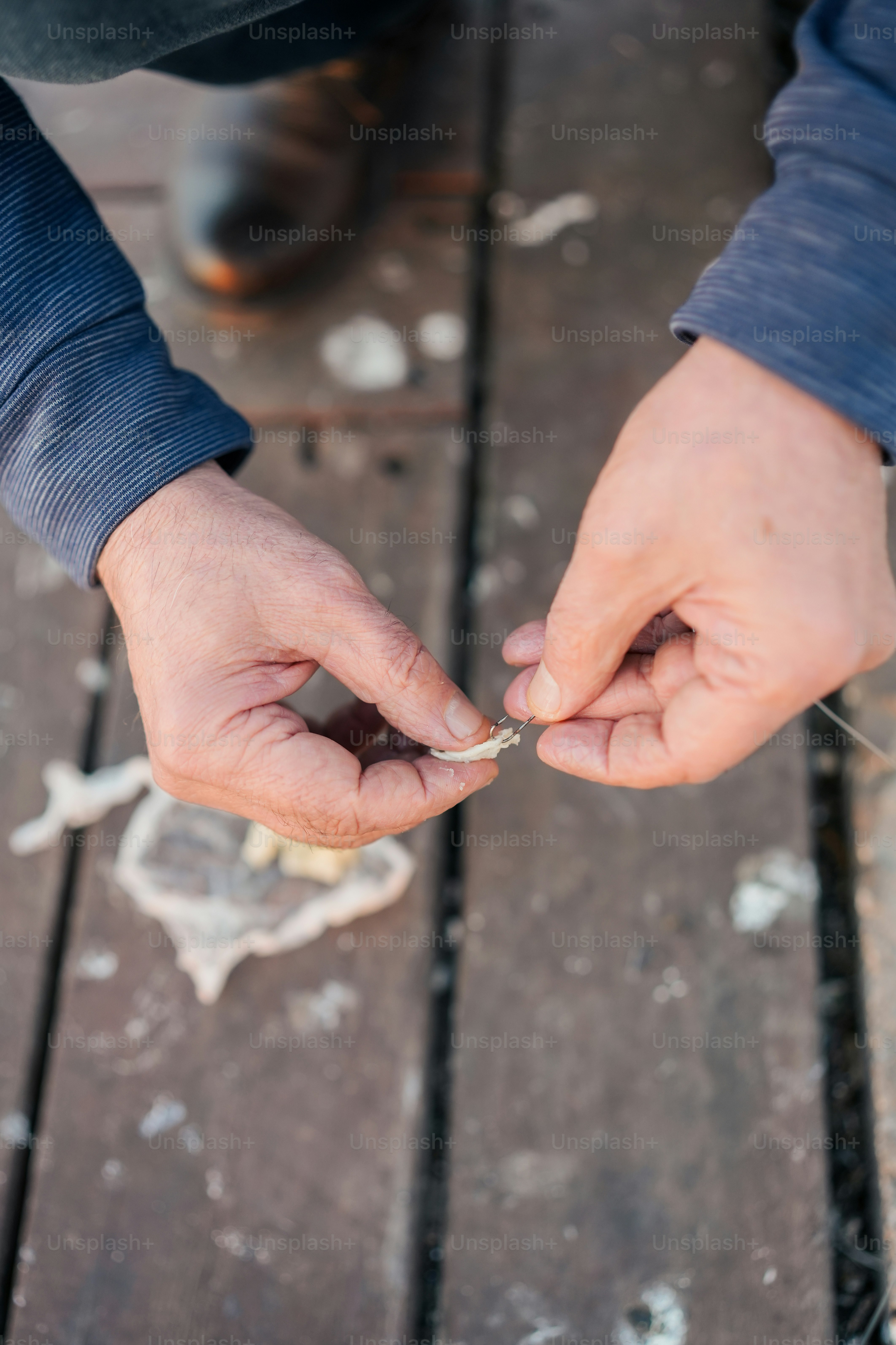 a person holding a cigarette in their hands