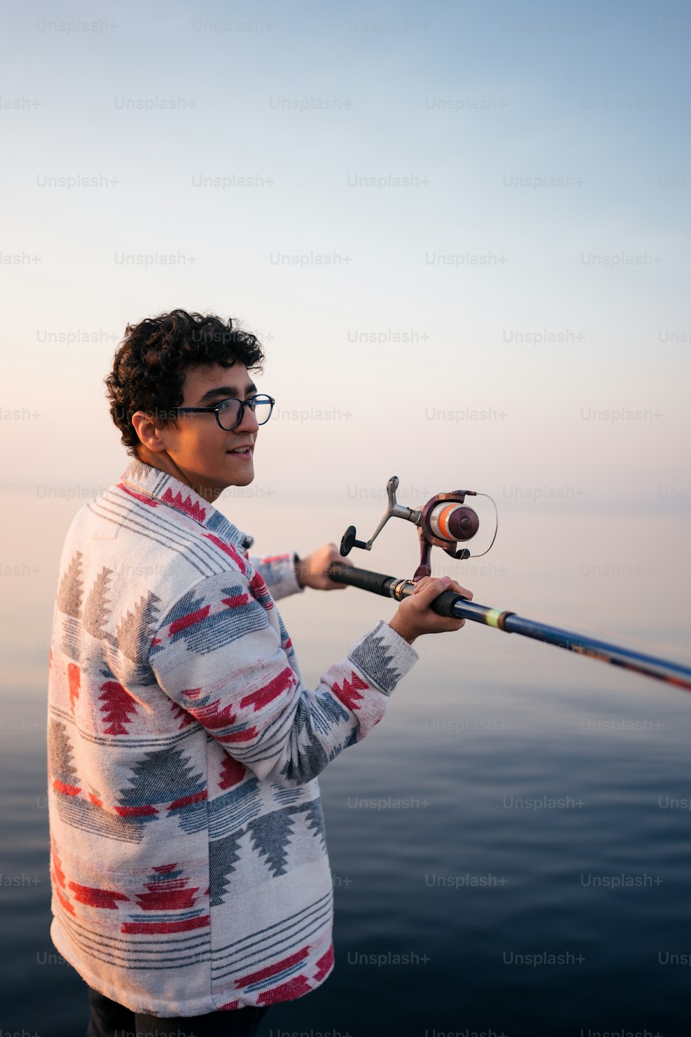 a woman holding a fishing rod on a boat