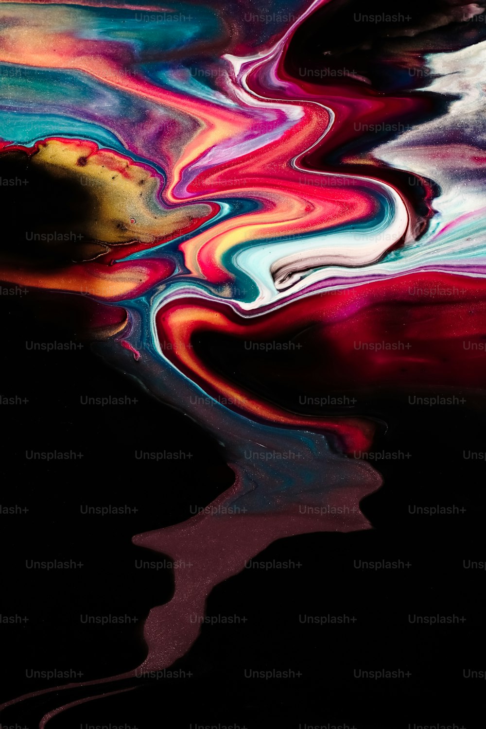 a black background with multicolored fluid paint