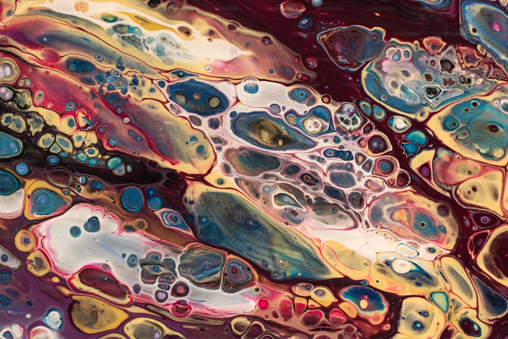 a close up of a liquid painting with lots of bubbles