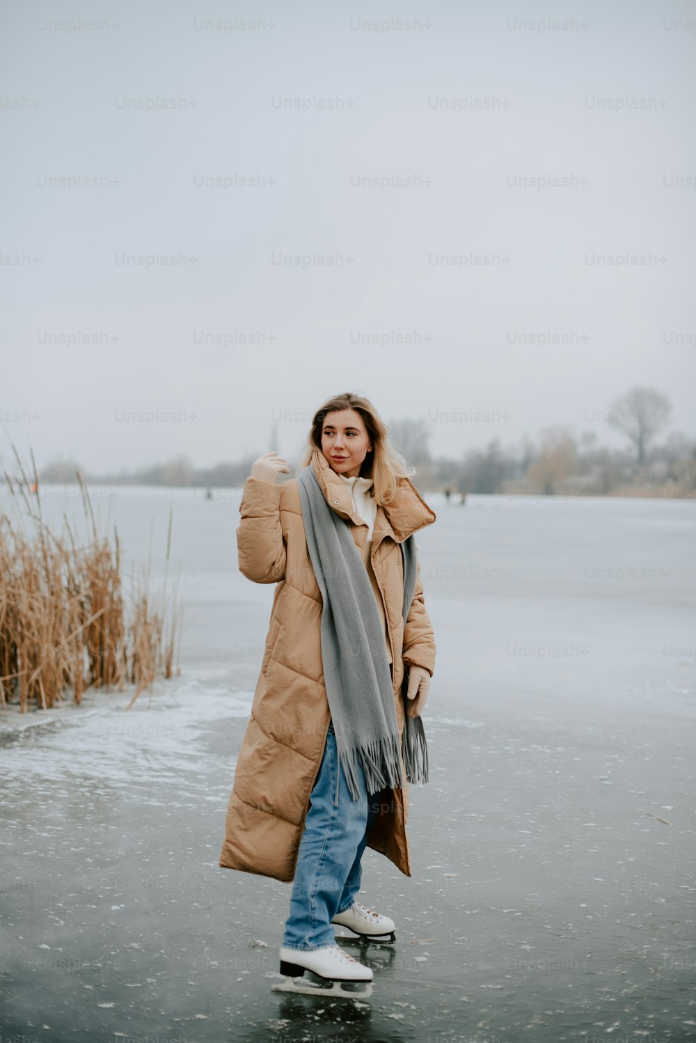Una mujer está parada en un lago congelado