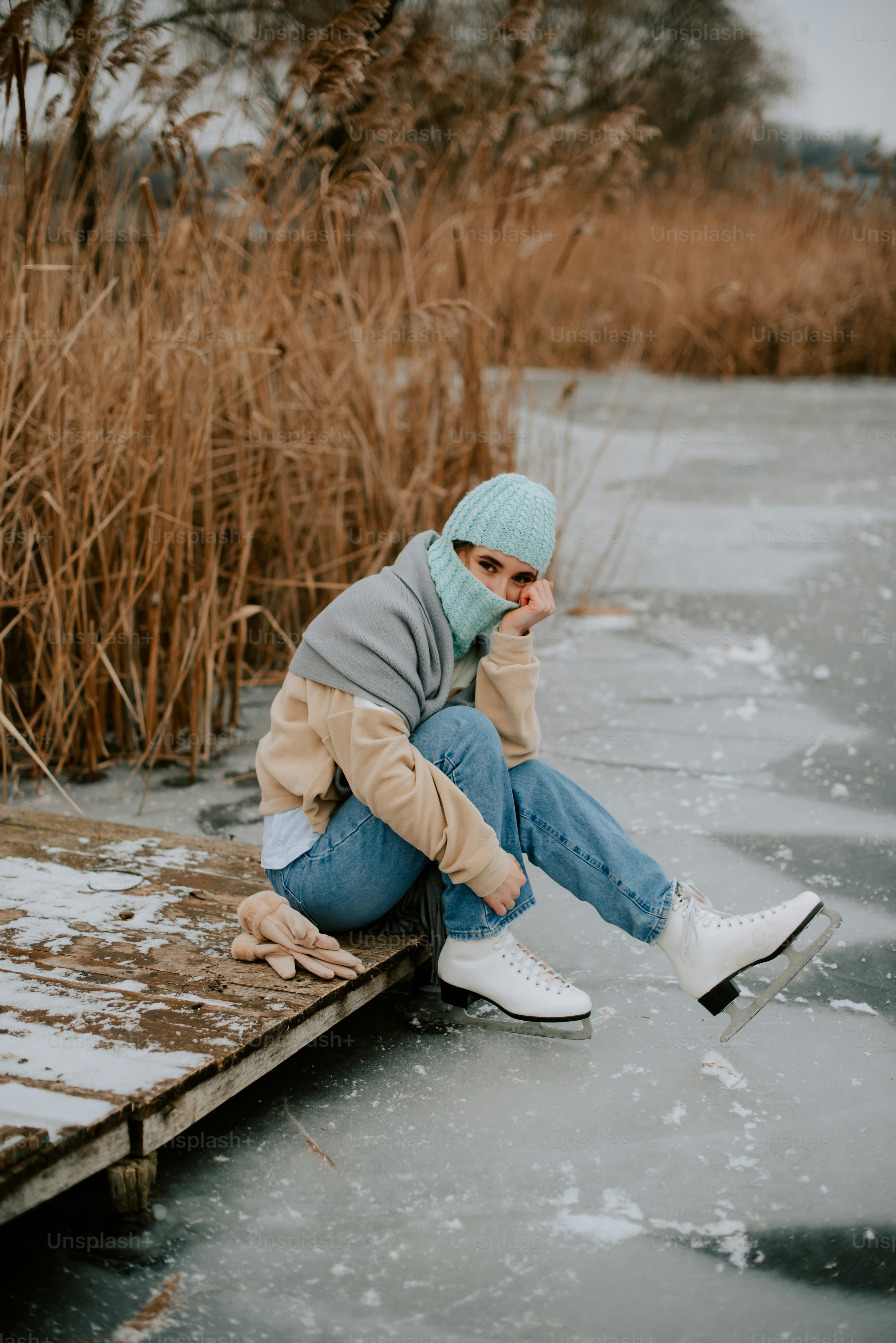 a person sitting on a dock with a cell phone