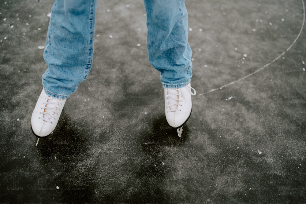 a person wearing white tennis shoes standing in a circle