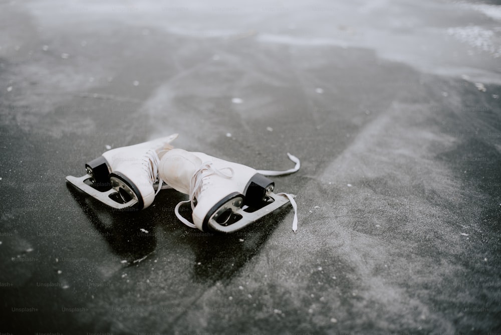 a pair of ice skates sitting on top of a frozen lake