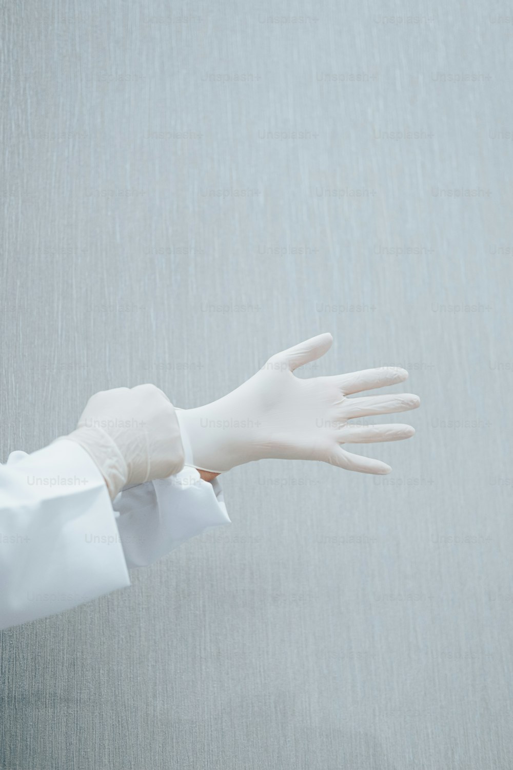 a gloved hand with a white glove on it