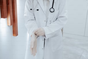 a doctor wearing a white coat and white gloves
