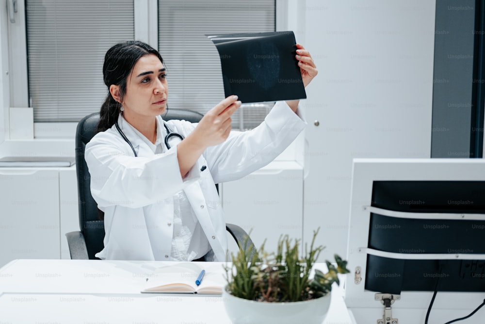 a woman in a white lab coat is holding a black folder