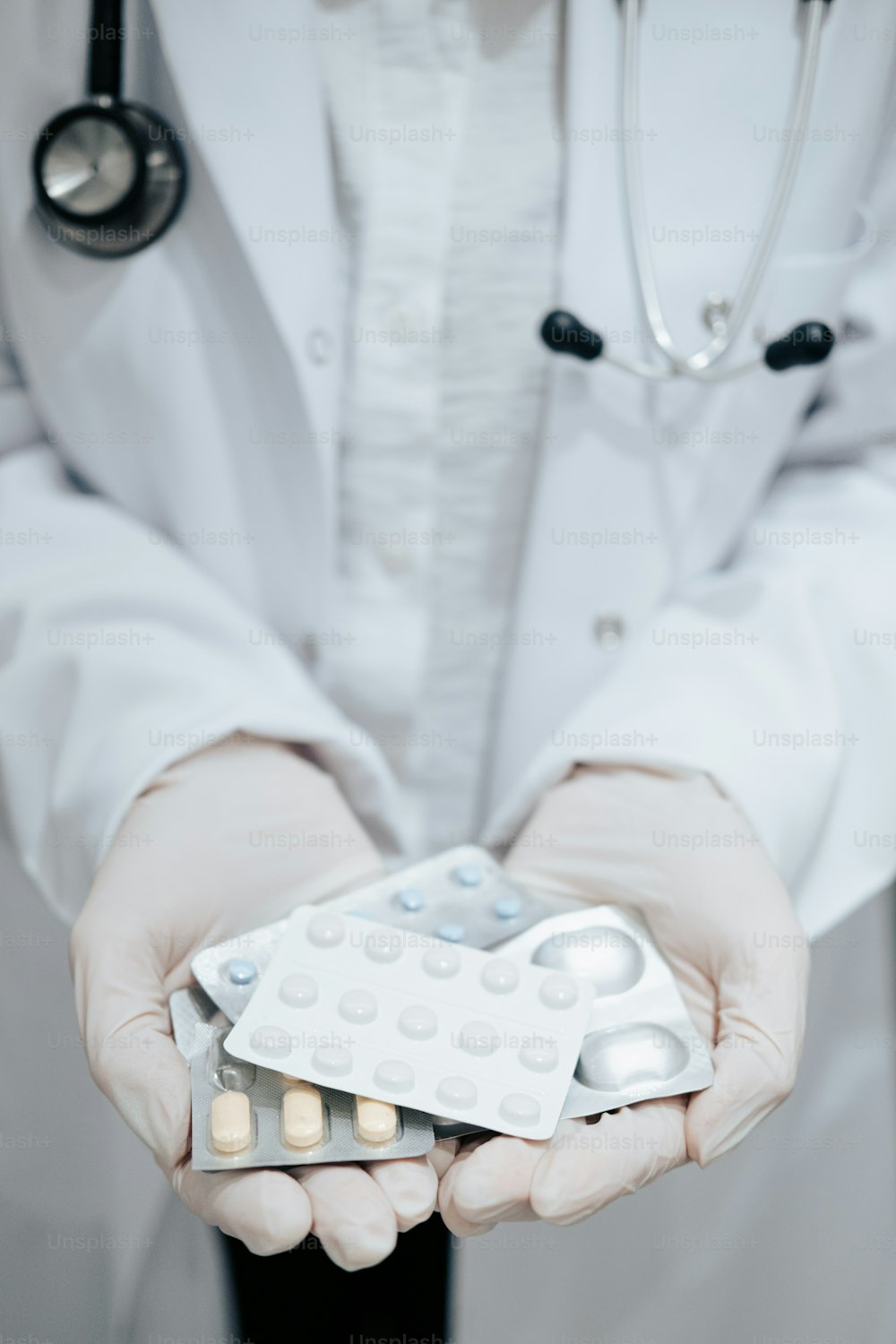 a doctor holding a pack of pills in his hands